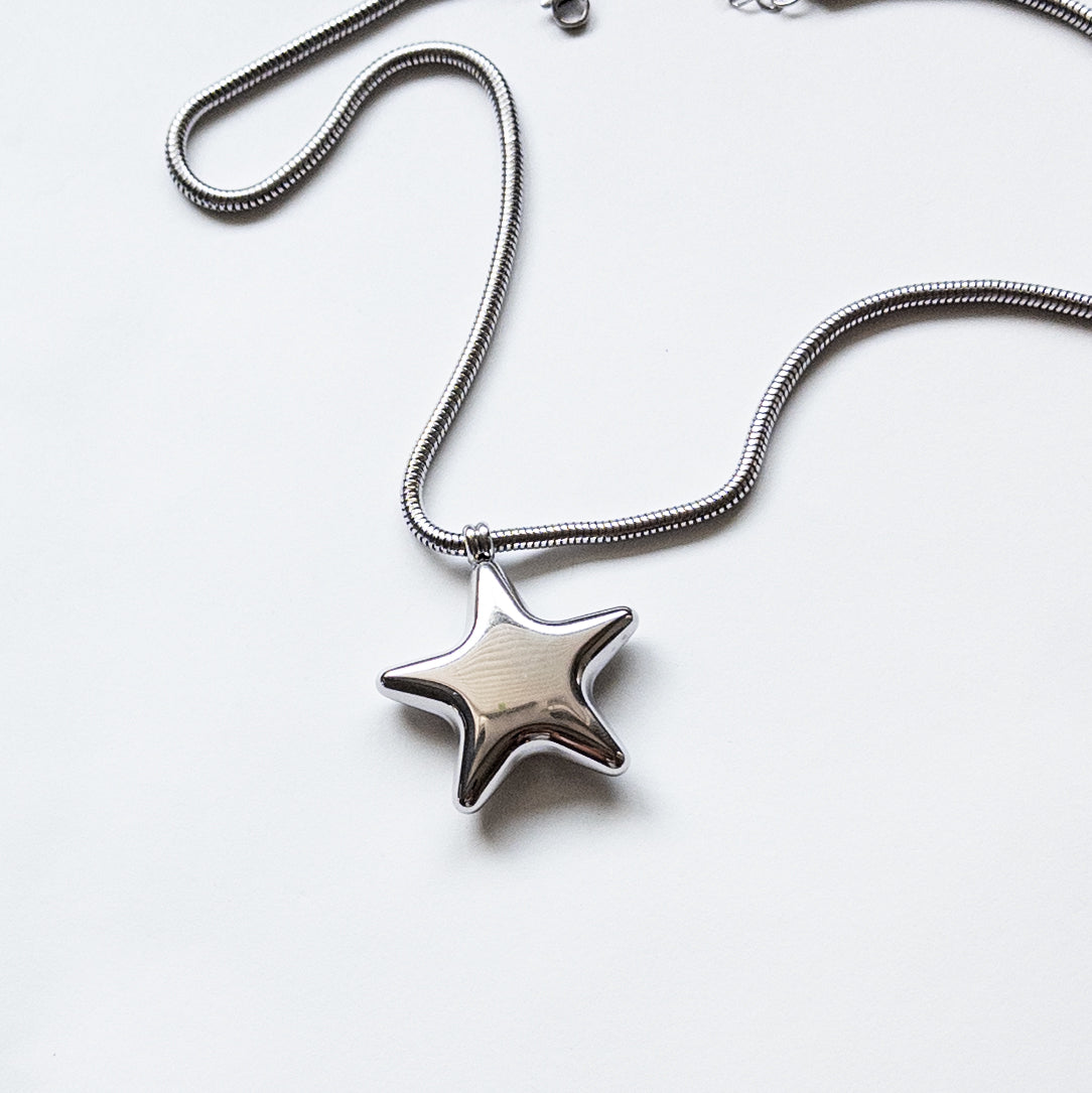 Stainless steel silver puffy star pendant on a thick snake chain.