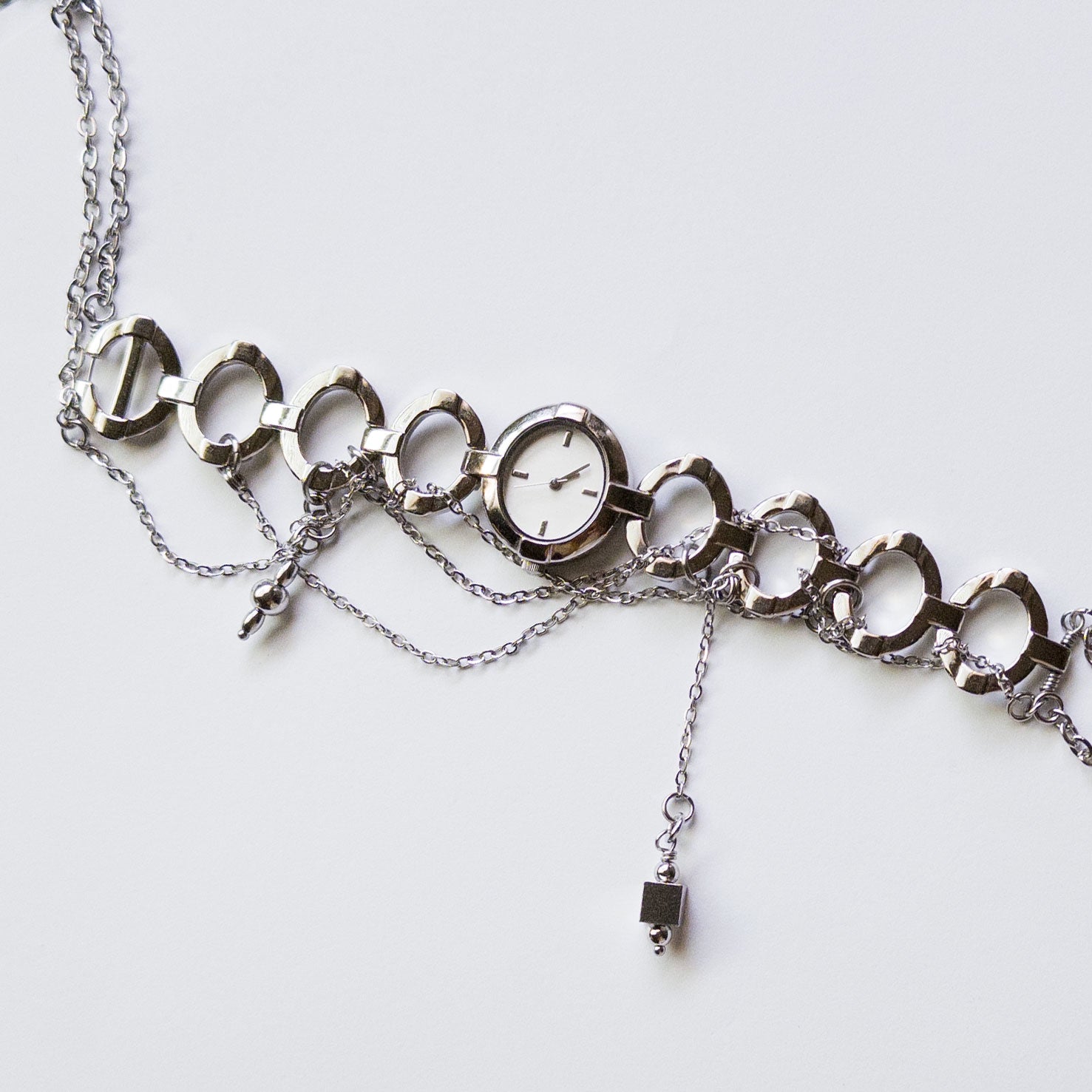 upcycled vintage watch choker necklace with dangling silver charms stainless steel