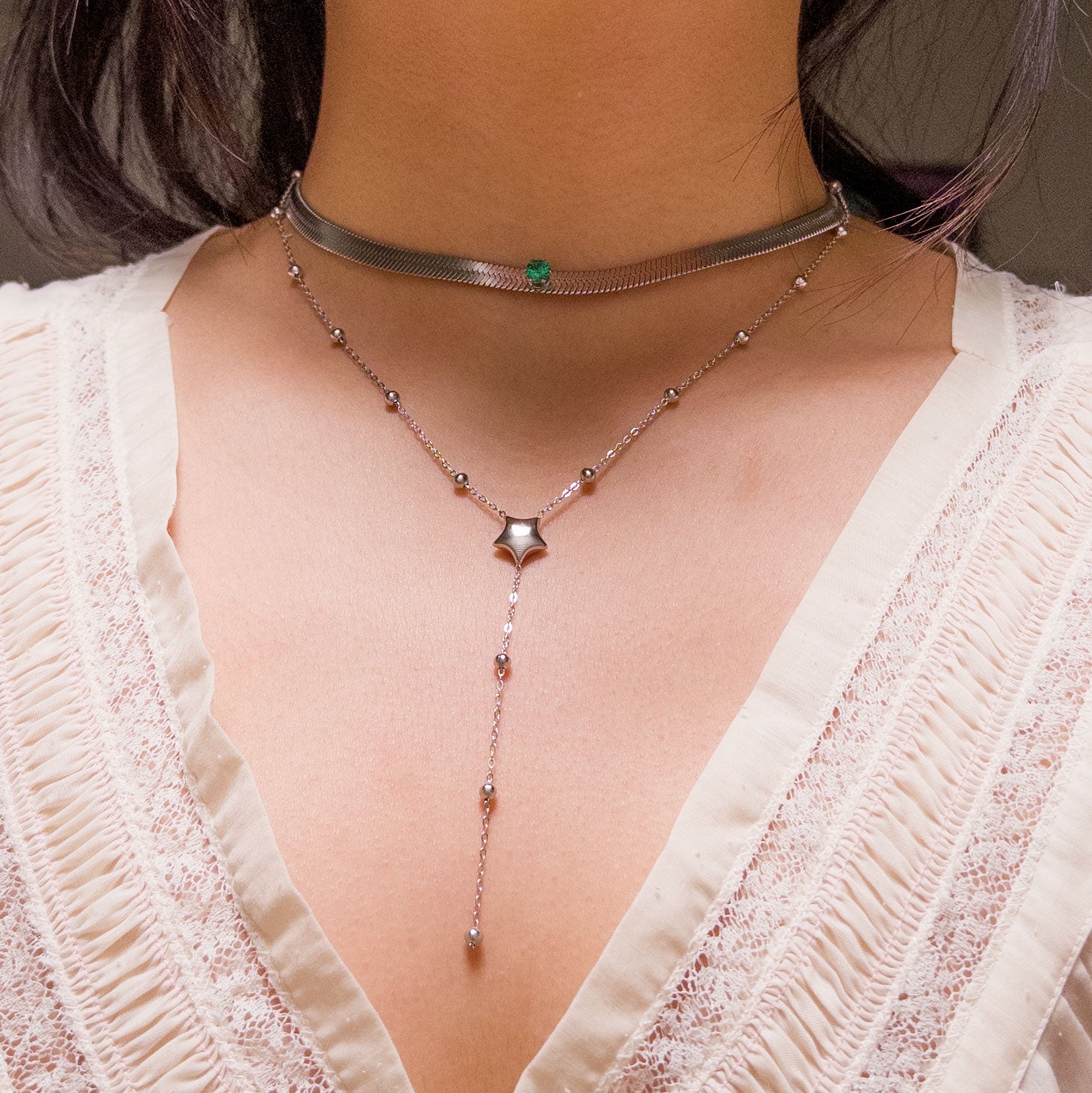 Stainless steel silver colored snake chain choker/necklace featuring a sage green cubic zirconia gem in the center. Can be dress up or down. Perfect for layering and everyday wear. 