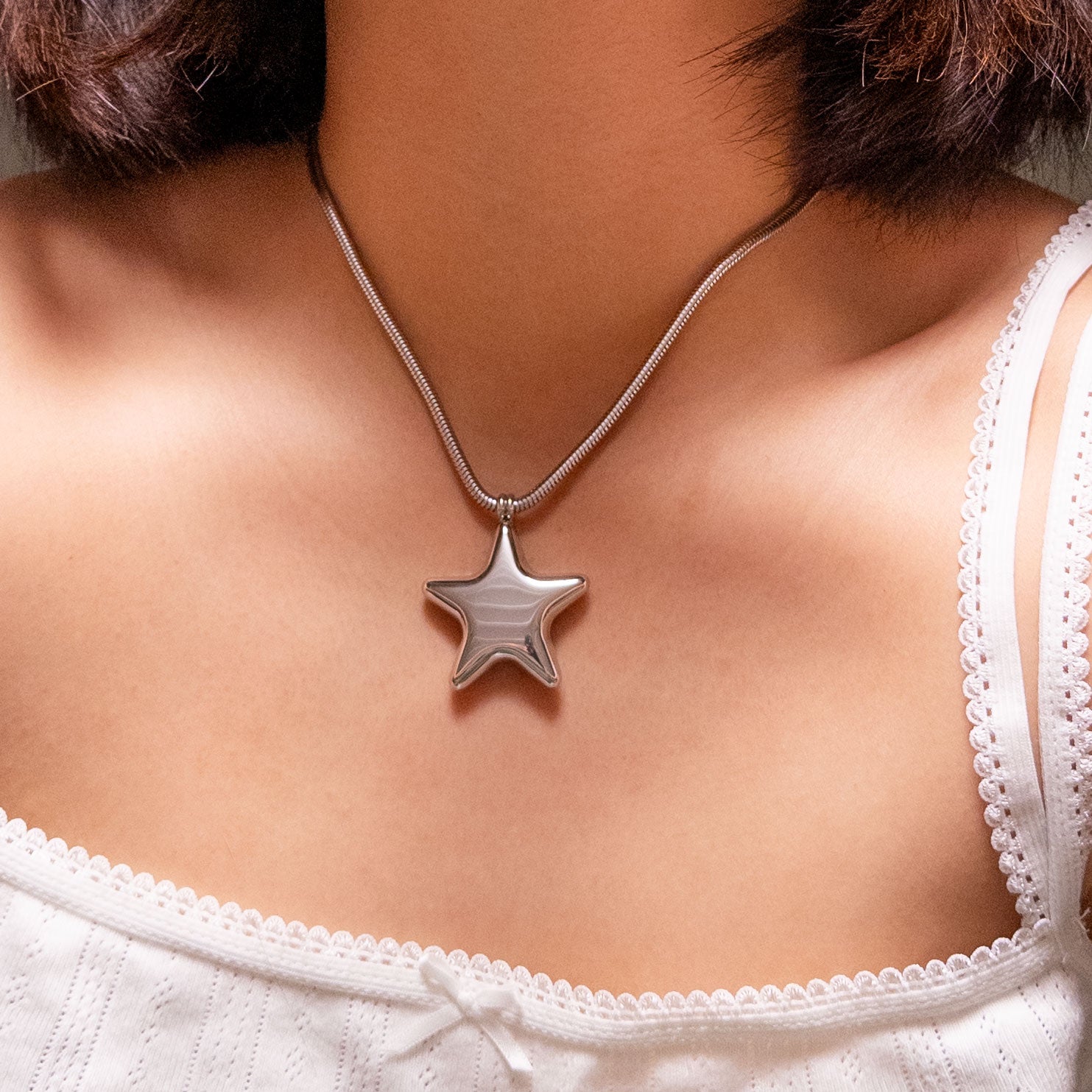 Stainless steel silver puffy star pendant on a thick snake chain.